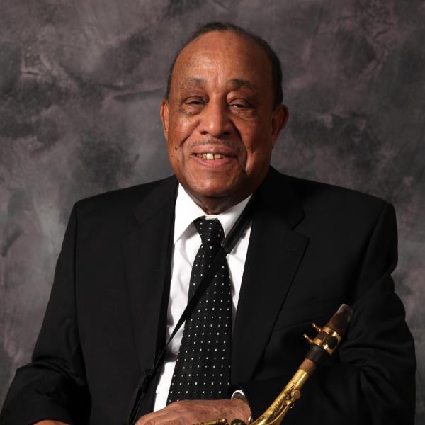 Man holding a saxophone. 